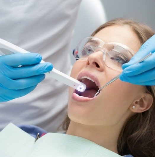 Woman receiving a dental exam with an intraoral camera