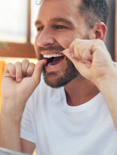 Man flossing his teeth