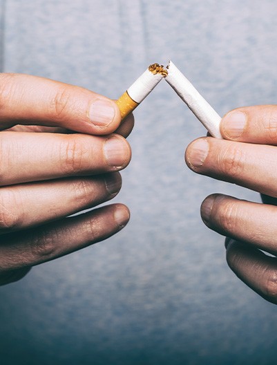Man breaking a cigarette