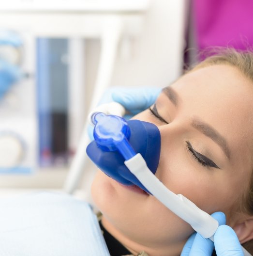 Young woman with eyes closed wearing nitrous oxide sedation dentistry mask