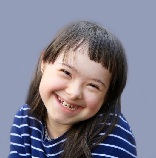 Smiling young girl with special needs