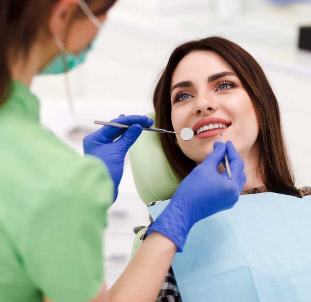 Woman smiling while receiving dental services in Northbrook