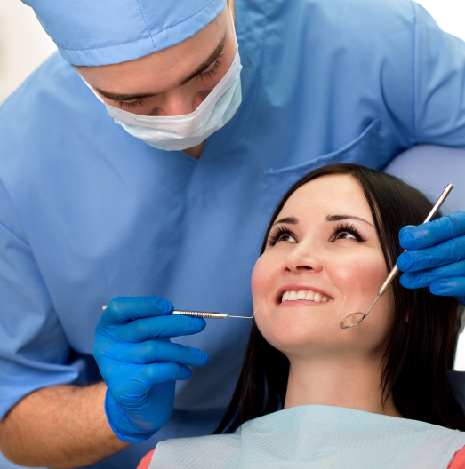 Woman smiling while receiving treatment from emergency dentist