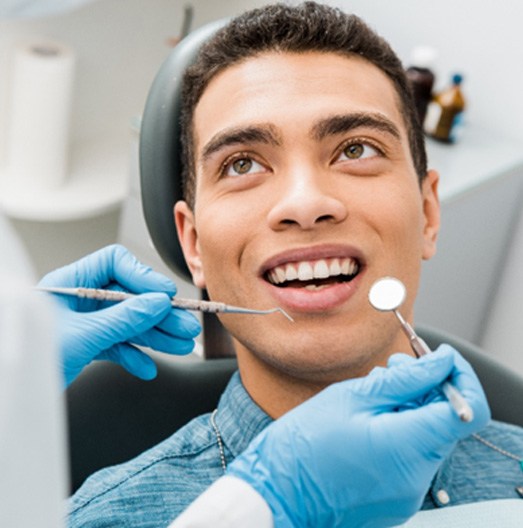 man smiling while visiting dentist