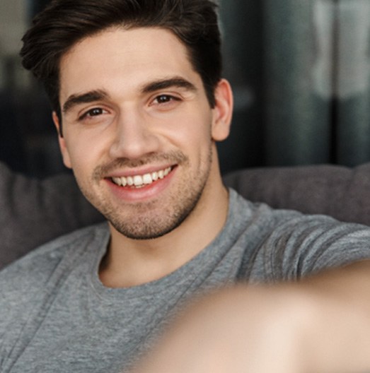 man smiling while looking into the camera