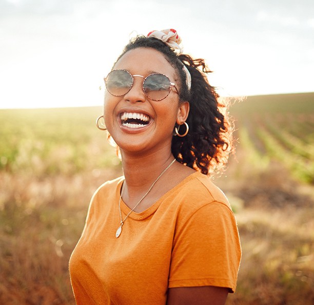 Woman in orange shirt smiling