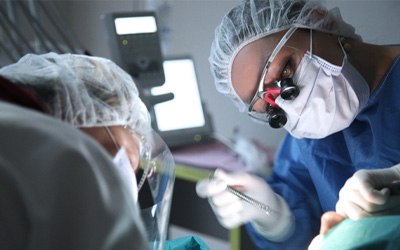 Dentist performing surgery