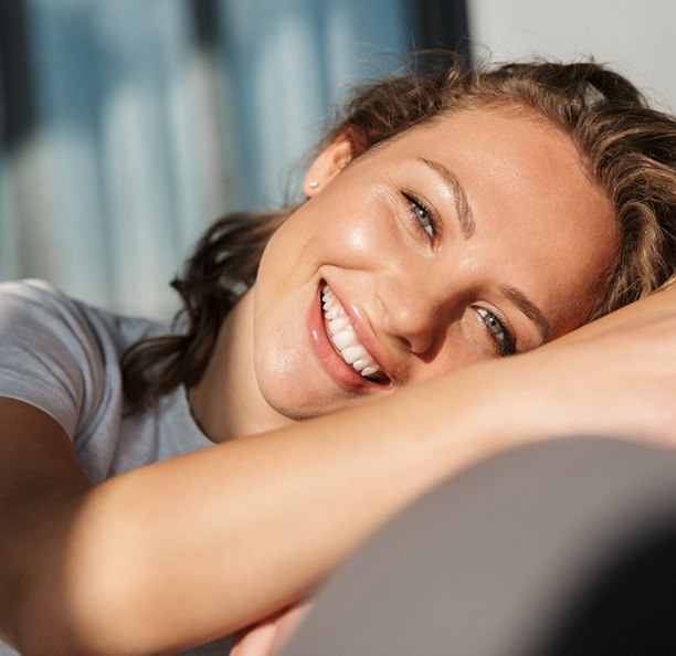 Smiling young woman with perfect teeth after a smile makeover in Northbrook