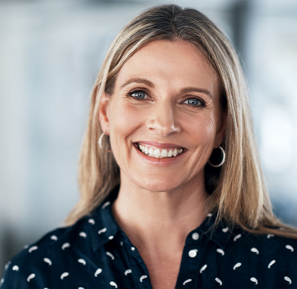 Blonde woman smiling after preventive dentistry in Northbrook