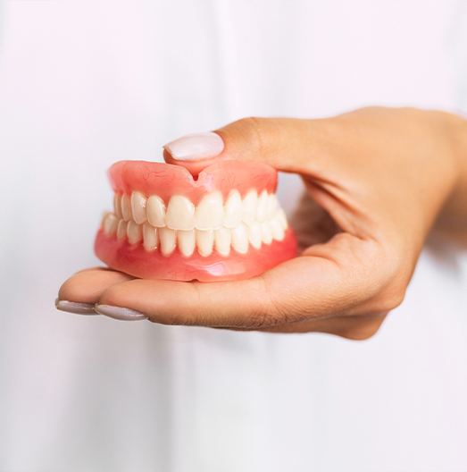 Dentist holding a set of full dentures