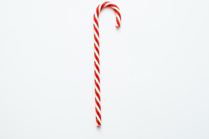 Close-up of a single candy cane on a white background