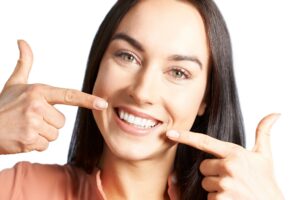 Smiling woman pointing to her teeth