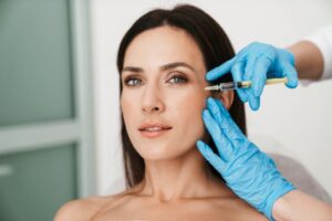 Woman receiving BOTOX injection near her eye 